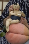 Momotaro sits
                      on his peach